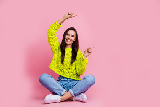 Photo of stunning pretty lady wear yellow stylish clothes two arms above head demonstrate empty space isolated on pink color background