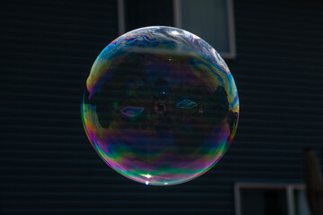 A clear bubble with reflection against a dark background.
