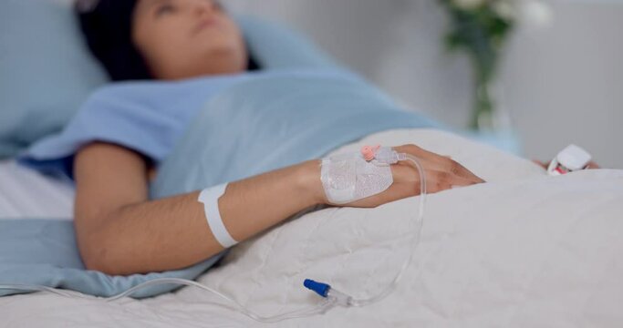 Hospital, emergency and hand of woman with iv drip in a bed for liquid, hydration or treatment. Healthcare, medicine and female patient with fluid, supplement and health, monitoring or recovery