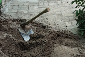 a hoe on the sand used for building