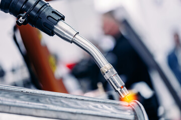 Welder robot arm on manufacturing CNC professional lathe machine, Industrial concept