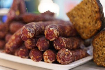 The market offers raw smoked sausages and bread.