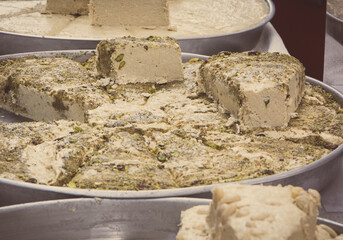 Halva with vanilla and pistachio on stall at bazaar. High calorie snack