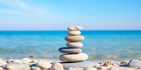 Zen stones by the sea, balance spa wellness concept, blue clear sky and sea, with copy space.