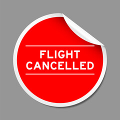 Red color peel sticker label with word flight cancelled on gray background