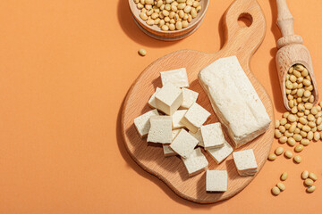 Fresh Tofu cheese with soybeans. Cube pieces, healthy ingredient for vegan lifestyle, modern stand
