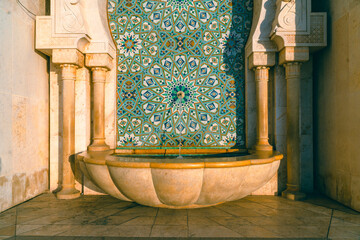 Hassan II Mosque fountain made of mosaic tile work , Detail of Hassan II Mosque at sunset in Casablanca, Morocco - obrazy, fototapety, plakaty
