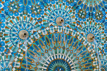The Hassan II Mosque exterior water fountain decorated with a beautiful moroccan mosaic pattern in Casablanca, Morocco. - obrazy, fototapety, plakaty