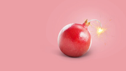 Creative juicy pomegranate bomb with wick and sparks burning, concept. Juicy explosion of vitamin...