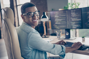 Photo of expert guy developer programmer looking at camera smiling when editing code creating new...