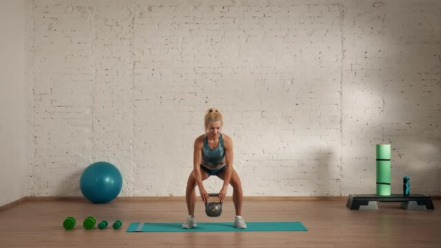 Healthcare and wellness advertisement concept. Athletic woman fitness coach doing squats with kettlebell side and front view.