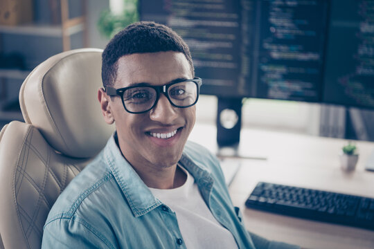 Portrait of young guy cheerful intelligent web developer professional javascript qa engineer guy create project at workplace indoors
