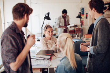 Obraz premium Young and diverse group of architects working on a project together in a startup company office