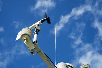 White weather station against a blue sky, meteorology