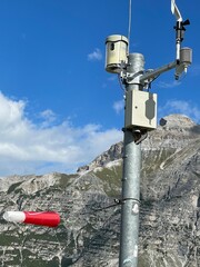 White weather station against a blue sky, meteorology