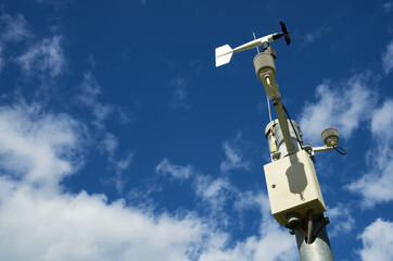White weather station against a blue sky, meteorology