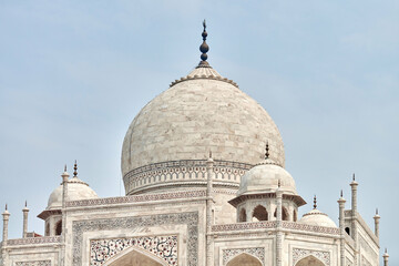 Fototapeta na wymiar Close up Taj Mahal dome white marble mausoleum landmark in Agra, Uttar Pradesh, India, beautiful dome of ancient tomb building of Mughal architecture, popular touristic place