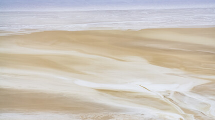 Top view of the shallow salt marsh Tuzbair on the Ustyurt plateau in Mangistau, texture of the desert coastline of the salt marsh