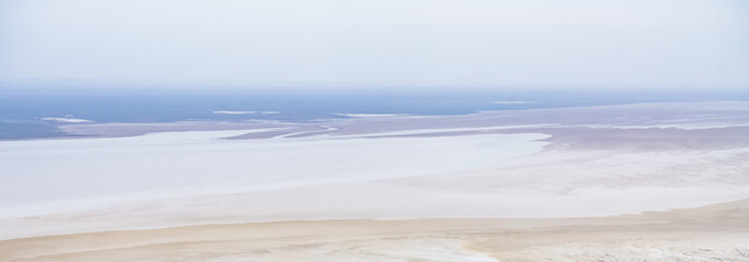 Fototapeta na wymiar Top view of the shallow salt marsh Tuzbair on the Ustyurt plateau in Mangistau, texture of the desert coastline of the salt marsh