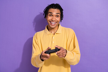 Photo of impressed person with dreadlocks earrings wear stylish shirt hold joystick play excited game isolated on purple color background © deagreez