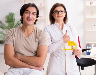 Female doctor checking patient's joint flexibility with goniomet
