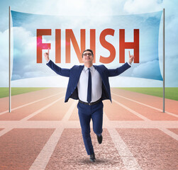 Businessman on the finishing line in competition concept