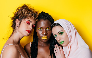 Three girls from different ethnicities posing in studio for a "body positivity" photo session