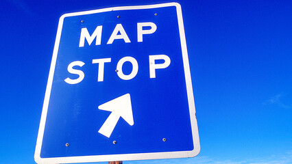 Low angle view of Map Stop road sign on California highway against blue sky