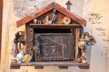 Stylish letterbox in the shape of a house with many decorations