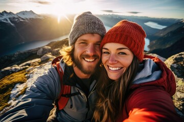 A happy, active couple enjoys nature and adventure, capturing their journey with a cheerful selfie in the beautiful landscape.