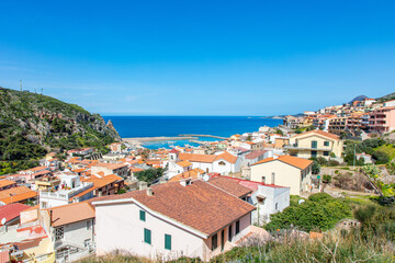 view from the top of the hill onto a beautiful and picturesque town Buggerru, Sardinia, Italy lying on the seashore of Mediterranean sea