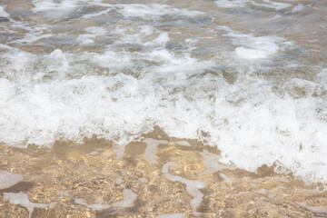 Fototapeta na wymiar beautiful waves rolling onto the sand