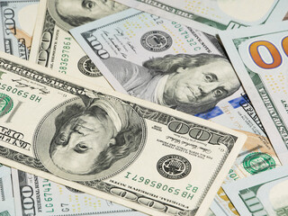 100 dollar bills with a close-up of the President.