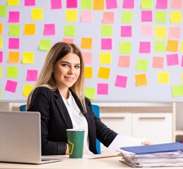 Young beautiful businesslady in conflicting priorities concept