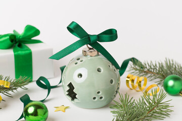 Lamp in Christmas bauble shape on color background