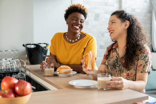 Brazilian couple eat snack and laugh at home