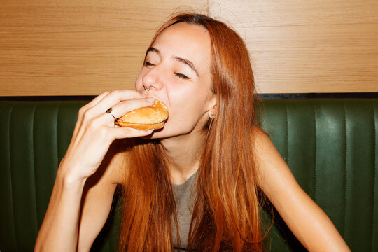 Young woman enjoy eating hamburger