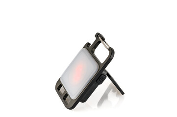 Mini LED flashlight for camping and other night outdoor activities isolated on white background. Close-up