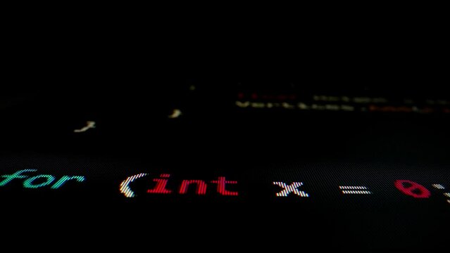 Closeup macro shot movement of coding script moving across LED screen with real-time AI-generated typing, showcasing advanced AI learning in optimization, debug and coding for software development.
