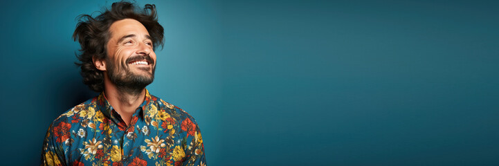 close up portrait of a isolated man wearing casual clothes smiling against a blue background. Banner design with space for text