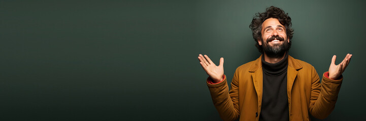 middle age man in a studio. happy smiling open arms and hands against a green background. Banner design with space for text