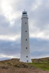 Photograph of Cape Wickham Lighthouse in a green field near Bass Strait on King Island in Tasmania in Australia