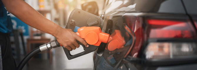 Gasoline being refilled at a petrol station. Refueling Diesel fuel is used to power a car.