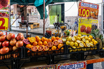 A juice stall stall in the open air market in Ballaró, Palermo, Sicily, Italy selling a variety of...