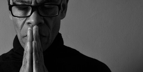 black man praying to god on gray background with people stock image stock photo