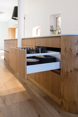 Fototapeta na wymiar modern kitchen with kitchen island and opened drawer