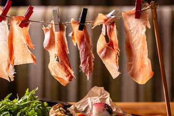Dry Spanish ham, Jamon Serrano, Bellota, Italian Prosciutto Crudo or Parma ham.Slicing Spanish...