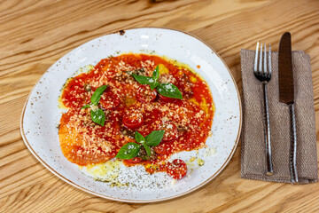 Spinach and ricotta ravioli with tomato sauce and parmesan.