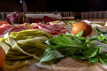 Raw pasta preparation, with ingredients, tomatoes, basil and eggs
