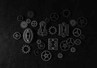 Assorted mechanical gears and vintage locks on dark background